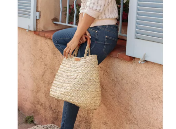 Hand‑woven palm leaf bag with leather handles