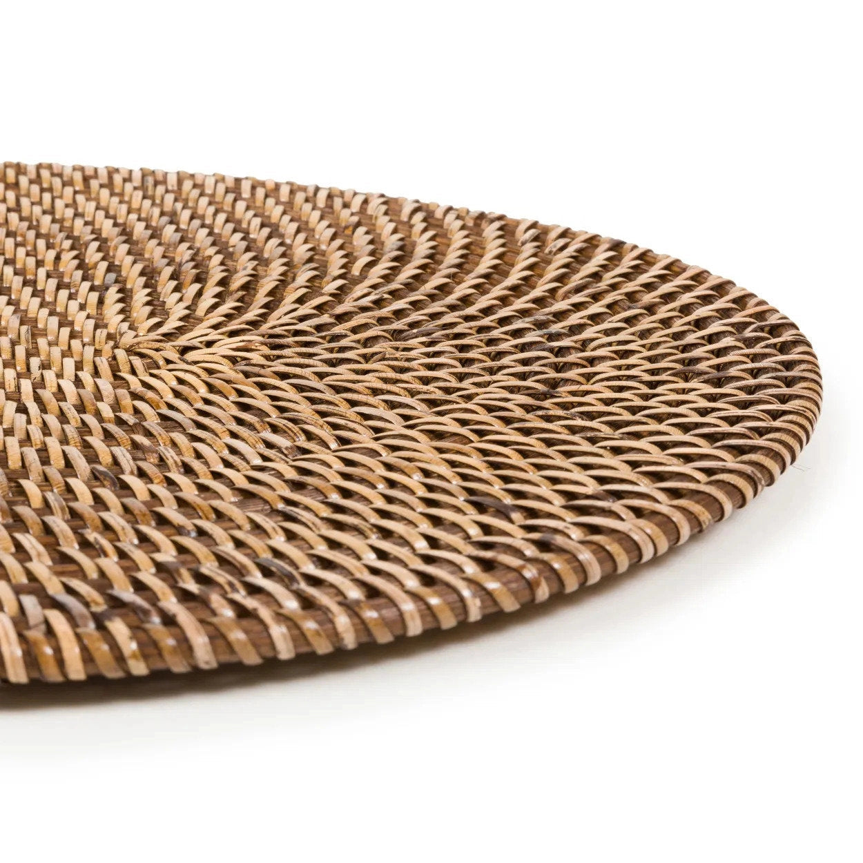 Handcrafted oval rattan placemat close up woven texture detail
