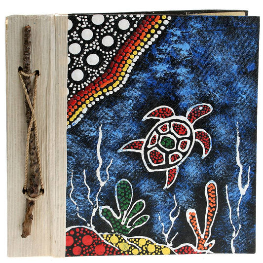 A notebook with an Aboriginal design featuring a colorful turtle on the cover