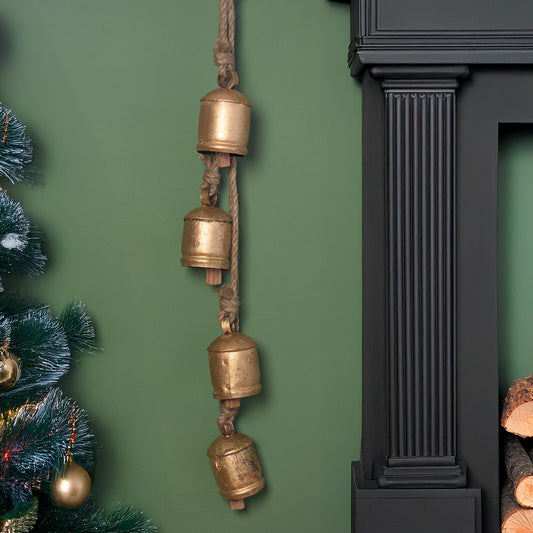 Four large vintage bells on rustic rope