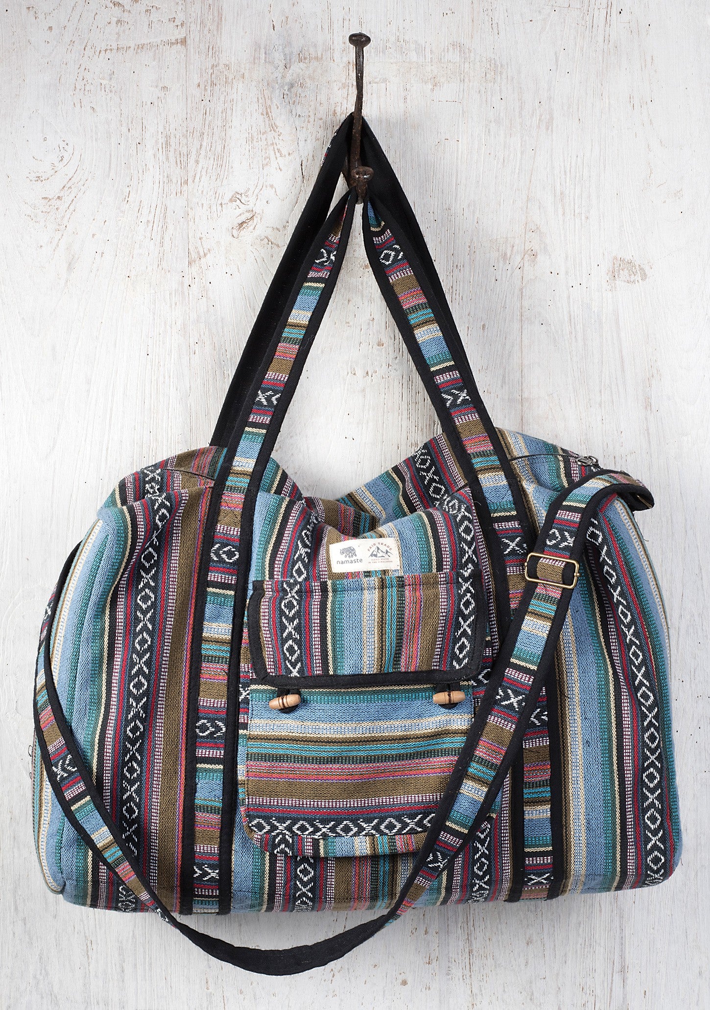 A handmade gheri fabric bag with multicolored stripes, featuring a shoulder strap.